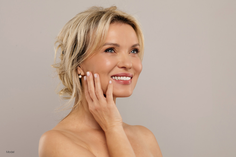 Mature woman touching her face