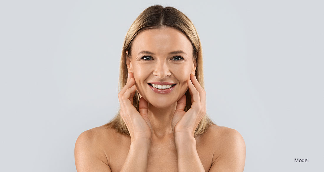 Mature woman touching her face