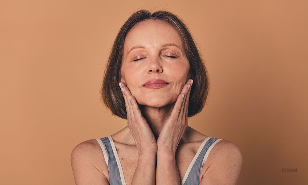 Mature woman touching her face